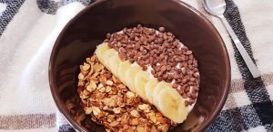 Yaourt nature, muesli, banane, et pépites de chocolat